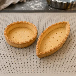 Golden round tartlet shell and pastry boat with thin walls and clean upright edges