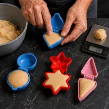 Cake-pop mixture is pressed into hinged plastic molds with filled edges and a clean compact seam